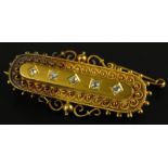A Victorian bar brooch, set with five tiny diamonds, with filigree design brooch, yellow metal,