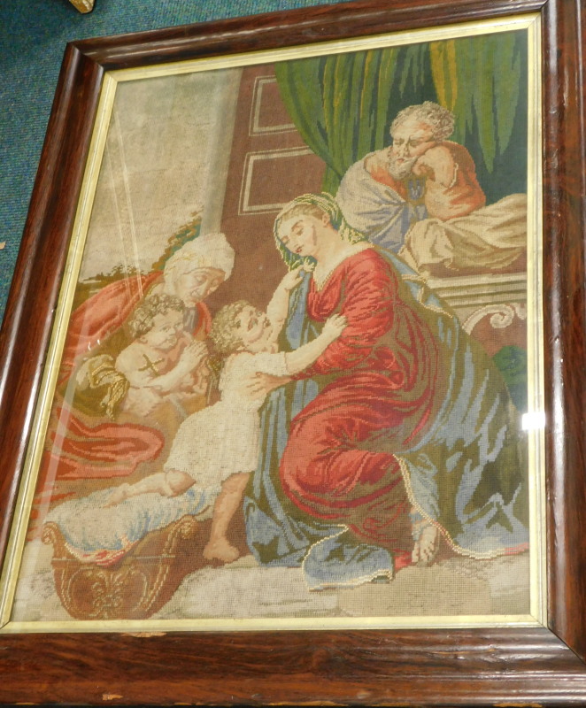 A 19thC woolwork picture, depicting children, figures etc., in contemporary figured mahogany cushion