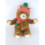 Withdrawn pre sale by vendor. A Harrods Bear, in brown with red and green scarf and hat, stamped