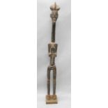 Tribal Art. A Koulango female figure from the Ivory Coast, with cream and red coloured bead