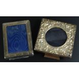 Two modern silver mounted photograph frames, in Edwardian style, embossed with figures, scrolls