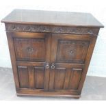 An Old Charm style small cupboard, with two panelled doors, on bracket feet, 90cm wide