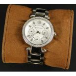 A modern Michael Kors fashion watch, with white enamel dial, set with white stones, on stainless