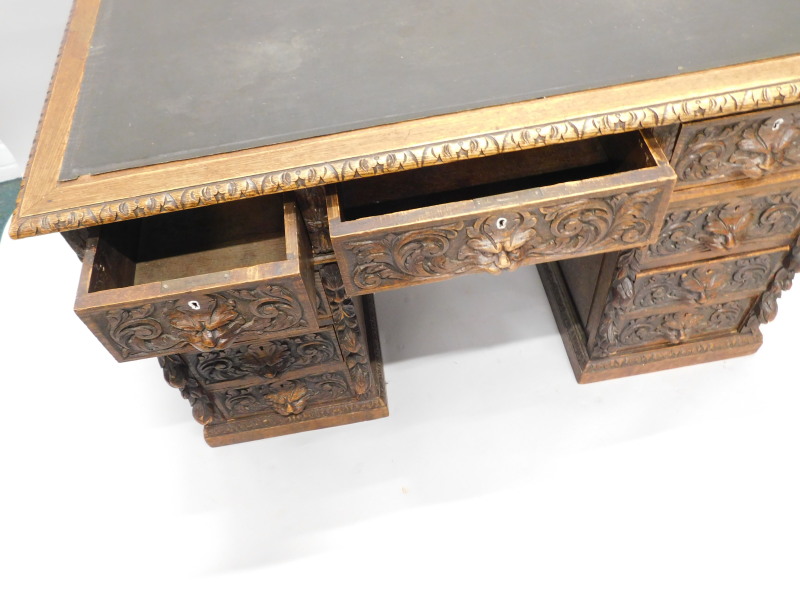 A Victorian oak pedestal desk, carved overall with foliate scrolls, masks, etc, the rectangular - Bild 2 aus 2