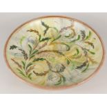 A Denby Glyn College shallow bowl, decorated with multi coloured leaves, within a brown border,