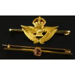 Two bar brooches, to include a topaz set yellow metal bar brooch, and a yellow metal bar brooch,