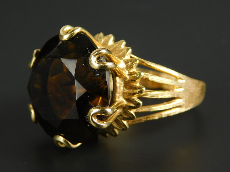 A smoky quartz dress ring, in claw setting, on five bar openwork band, yellow metal, unmarked.