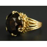 A smoky quartz dress ring, in claw setting, on five bar openwork band, yellow metal, unmarked.