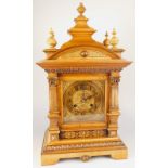 A late 19thC German walnut mantel clock, with pressed metal dial, the case carved with stylised