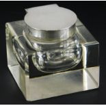 A square section glass inkwell, with silver hinged lid and collar, marks indistinct, 8cm wide