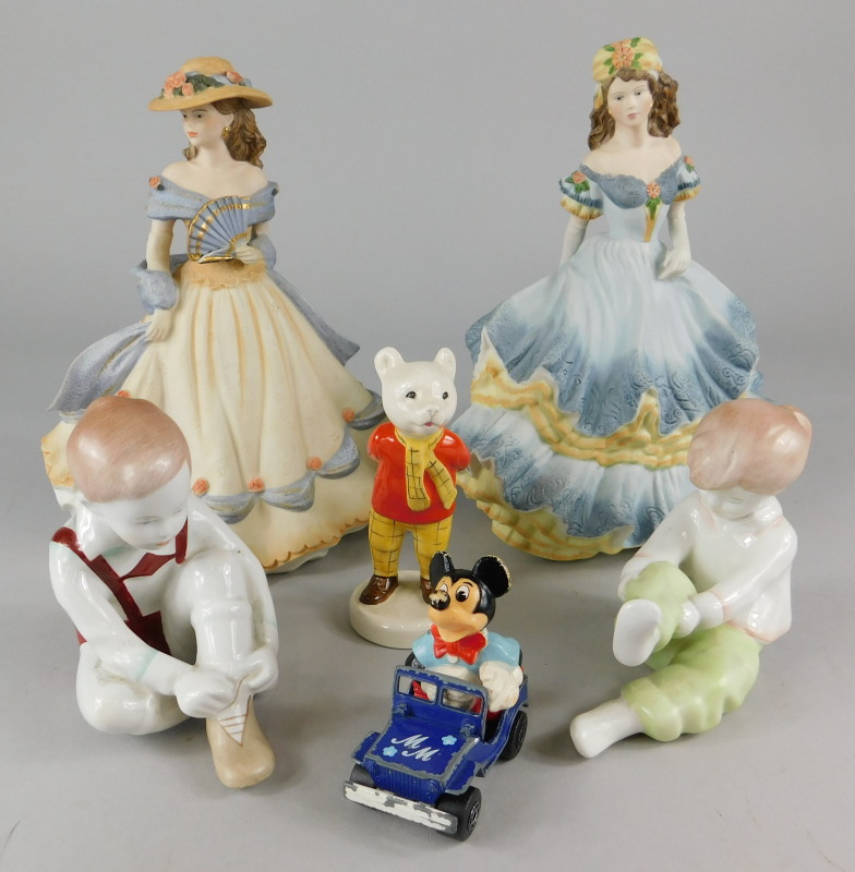 Various porcelain figures, to include two Coalport bisque ladies, Rupert Bear, Continental book ends