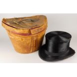 A top hat and an early 20thC leather hatbox. (AF)