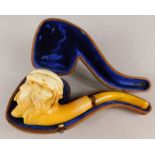 A Meerschaum pipe, carved with an Arab style figure, in a suede leather case (AF)