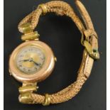 A wristwatch, on two row rope bracelet, with yellow metal watch head, unmarked.
