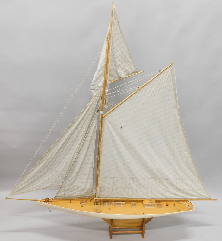 A large single masted pond yacht, with three sails on a stand, 169cm wide.
