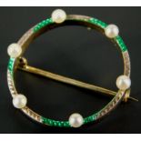 A Victorian circular brooch, set with six seed pearls and decorated with green enamel, white and
