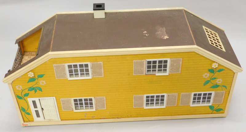 A 1980's/90's retro style plastic and painted card dolls house