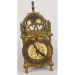 A Smith's eight day brass lantern type clock, with turned feet, etc, 15cm high.