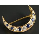 A 9ct gold diamond and sapphire crescent brooch, set with eight sapphires and seven diamonds, 2.8g
