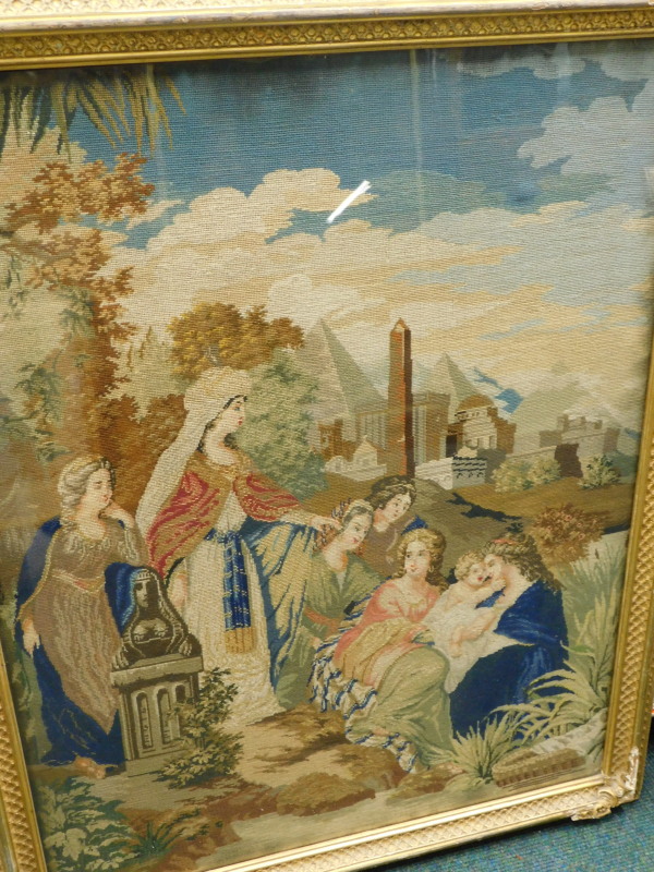 A Victorian woolwork picture, depicting Moses in the bulrushes with various figures, pyramids