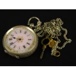 A silver pocket watch, with pink enamel dial, gold motifs, blue hands, key wind, marked 935, on a