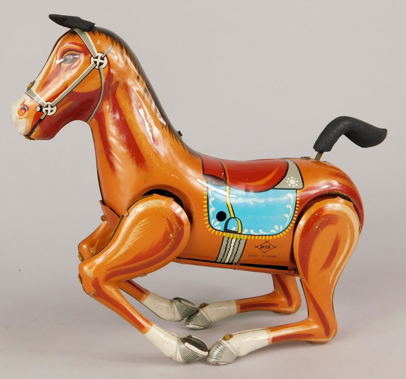 A Japanese Daiya tinplate clockwork bucking horse, with key etc, 16cm long.