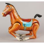 A Japanese Daiya tinplate clockwork bucking horse, with key etc, 16cm long.