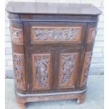 An oriental style heavily carved D-end side cabinet, with drawers above cupboards