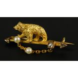 A bear bar brooch, a figure of a bear, on bar, set with seed pearls and one white stone, gold