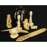 A collection of ivory and bone etc., to include chess pieces, a crude carving of a boy, possibly