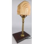 An Art Deco style brass table lamp, with part frosted glass shade and later mahogany plinth, 48cm