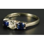 A sapphire and diamond ring, set with two baguette cut sapphires and a round brilliant cut