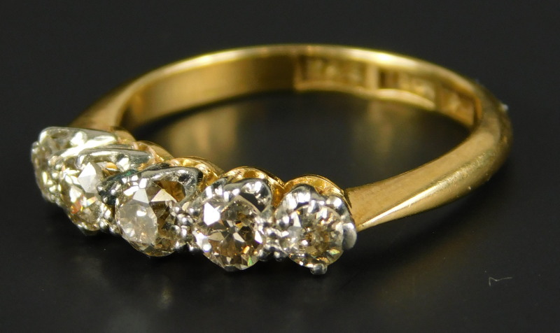 A five stone diamond dress ring, set with five tiny diamonds each approx 0.05cts, yellow metal,