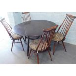 An Ercol style oak drop leaf kitchen table and four stickback chairs.The upholstery in this lot does