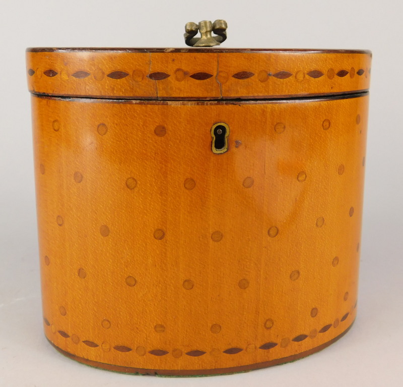 An early 19thC satinwood oval tea caddy, the hinged lid inlaid with roundels and lozenges,