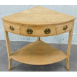 A 19thC pine bow fronted corner wash stand, with a single drawer, flanked by two false drawers, on