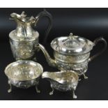 An Edward VII Irish silver four piece tea service, each embossed with foxes, swans, vines etc., on