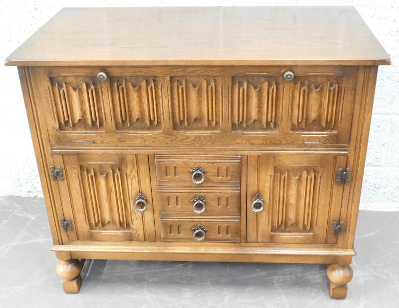 An Old Charm style hi-fi cabinet, with linen fold panels, drawers etc.