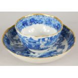 A late 19thC Chinese export blue and white tea bowl, painted with a landscape with buildings