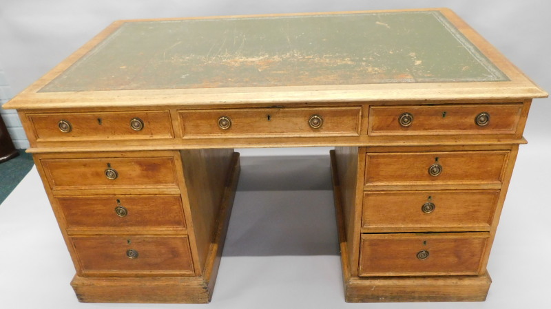 A late 19th/early 20thC oak partner's type desk, the rectangular top with a green leather insert and