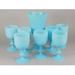 A collection of turquoise opaque glass goblets, and a vase. (7)