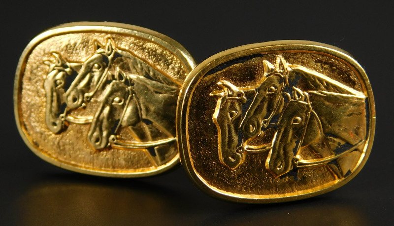 A pair of horse cufflinks, each on oval shield, set with three horses, yellow metal, unmarked,