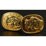 A pair of horse cufflinks, each on oval shield, set with three horses, yellow metal, unmarked,