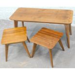 A group of three matching tables, each 1970's retro style, comprising a walnut topped laminated