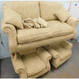 A large Parker Knoll two seat sofa, with beige fabric, turned legs and brass castors, two matching