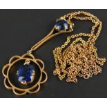 An Art Nouveau pendant, set with blue stones, in a floral drop, marked 9ct, on a fine link chain,
