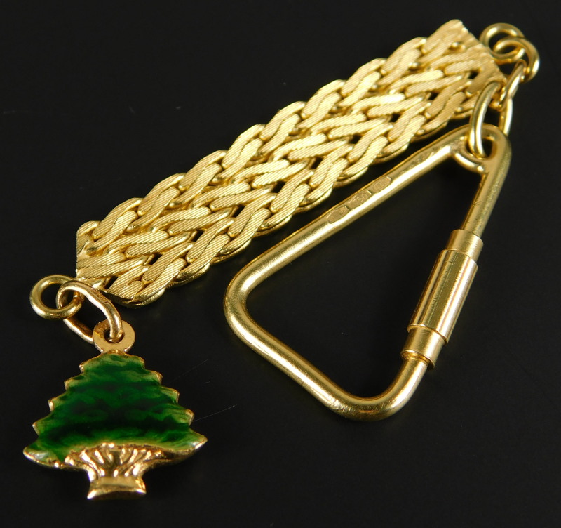 An 18ct gold keychain, with enamel decorated fir tree drop, 13.9g all in.