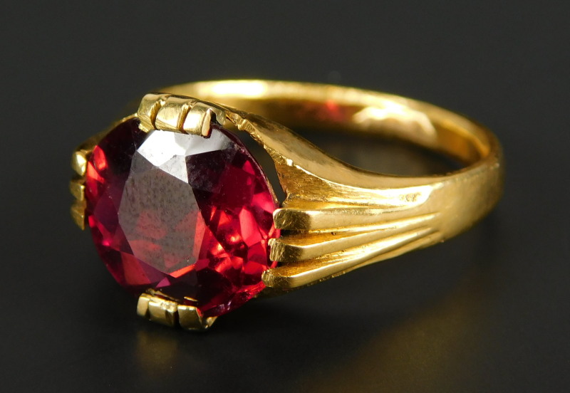 A ruby set dress ring, the oval cut ruby approx 3.55cts, with three row claw setting, yellow