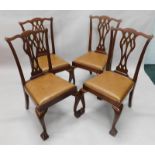 A set of four mahogany dining chairs, in George III style, each with a pierced splat, drop in