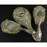 Two Edward VII silver Art Nouveau style brushes, Birmingham 1906 and an associated mirror